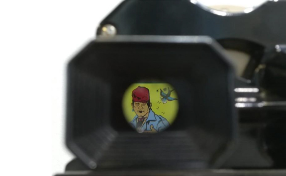 Colourful print of a man, viewed through a camera view finder 